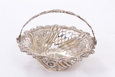 Lot 430 - George III silver sweet meat basket of circular form with pierced decoration and central swing handle.