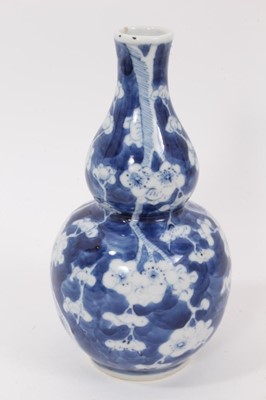 Lot 119 - 19th century Chinese blue and white double gourd vase, decorated with prunus blossom, four-character mark to base