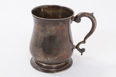 Lot 432 - George II silver tankard of baluster form with scroll handle, on circular foot, (London 1748), makers mark rubbed. All at 6ozs, 9.5cm in overall height.