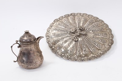 Lot 447 - Egyptian white metal mirror of oval form with floral decoration and Turkish silver jug and cover of baluster form with engraved decoration, marks to base (2)