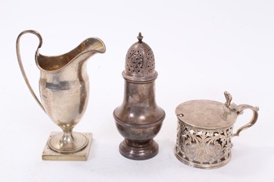 Lot 441 - William IV silver mustard pot of drum form with pierced decoration (lacking liner), (London 1835) together with a George V silver cream jug of helmet form (Chester 1912)