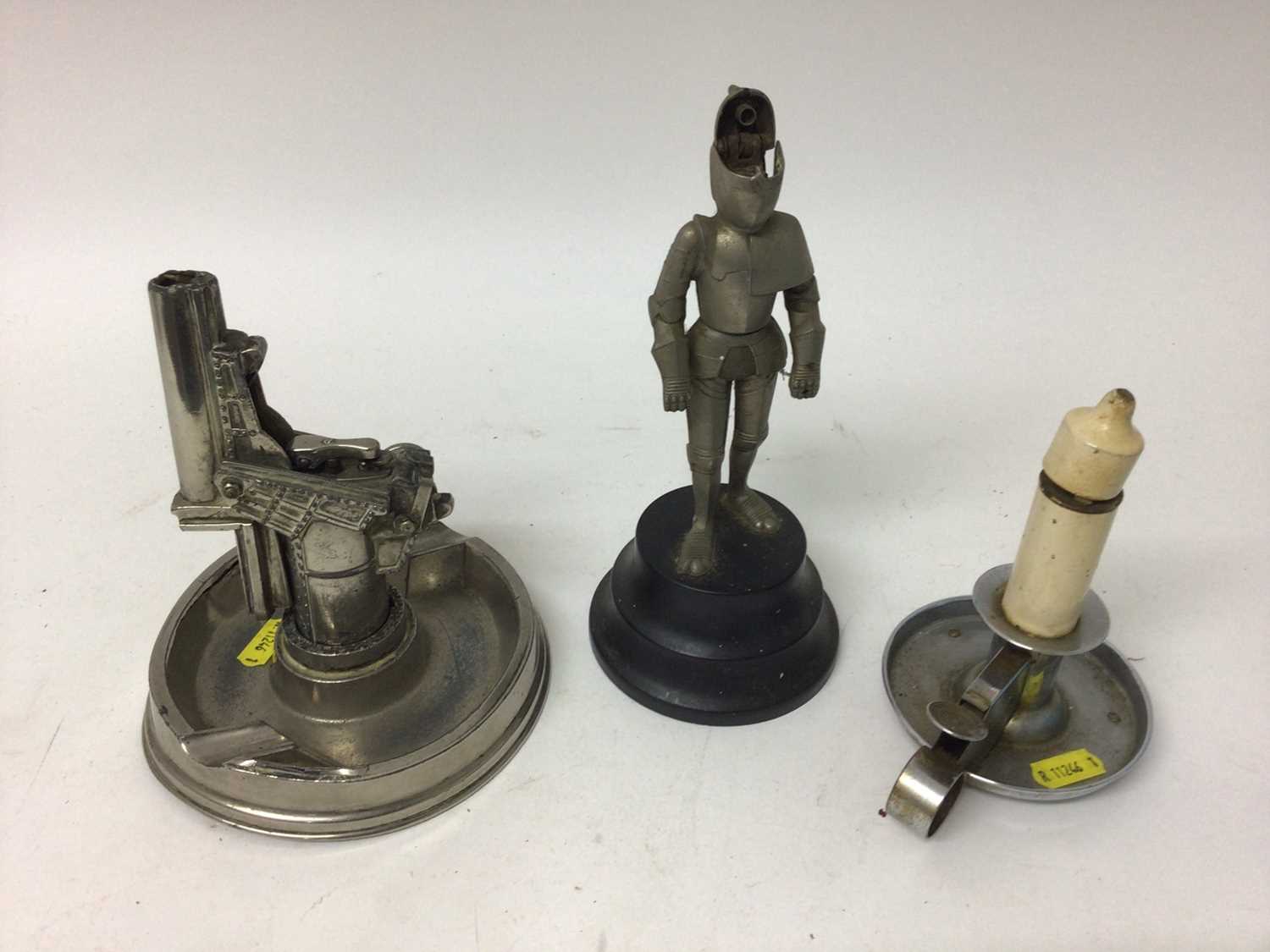 Lot 2440 - Three novelty lighters, including a candle, a gun and a knight in armour