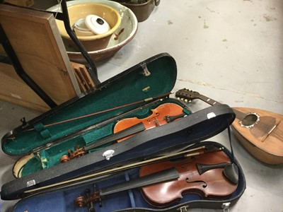 Lot 497 - Two cased violins with bows and a mandolin