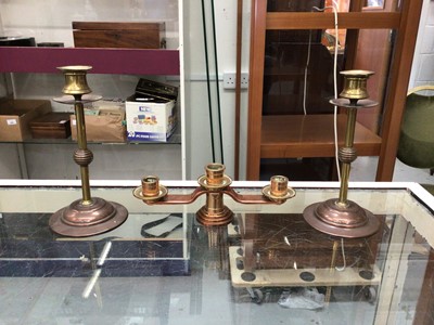 Lot 273 - Pair of Benson style copper and brass candlesticks, and another three branch candlestick (3)