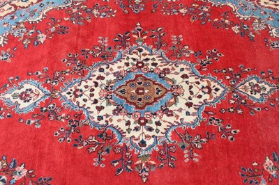 Lot 195 - Large Persian carpet on red ground