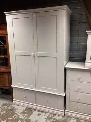 Lot 1207 - Contemporary bedroom suite comprising double wardrobe with two drawers below, chest of two short and three long drawers and a two drawer bedside chest (3)