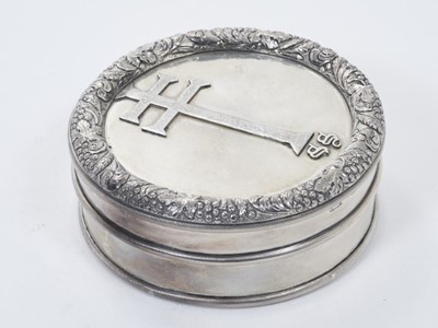 Lot 242 - George IV silver host pyx / wafer box of circular form with cast vine border and central patriarchal cross to slip on cover and gilded interior, (Exeter 1827), maker, J.F, 9.5cm in diameter.