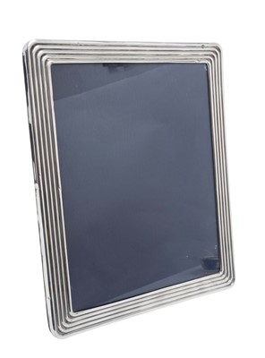 Lot 355 - Large Contemporary silver photograph frame of rectangular form with reeded deocration, and a two way easel back (London 1999), Kitney & Co. 30cm overall height.