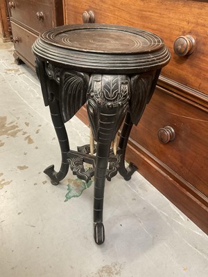 Lot 1260 - Antique Indian ebonized plant stand with elephant supports