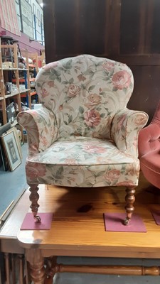 Lot 1268 - Victorian style armchair with floral upholstery on turned front legs