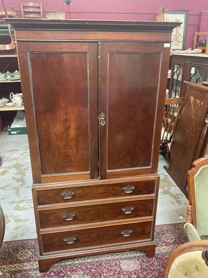 Lot 1292 - Edwardian mahogany two height linen press with mahogany trays enclosed by two panelled doors with chest of three long drawers below