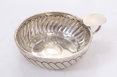 Lot 376 - George V silver wine taster of circular form with chased decoration, the base set with an Elizabethan silver hammered coin, with circular handle and oval thumb piece, (London 1910), makers mark rubbed