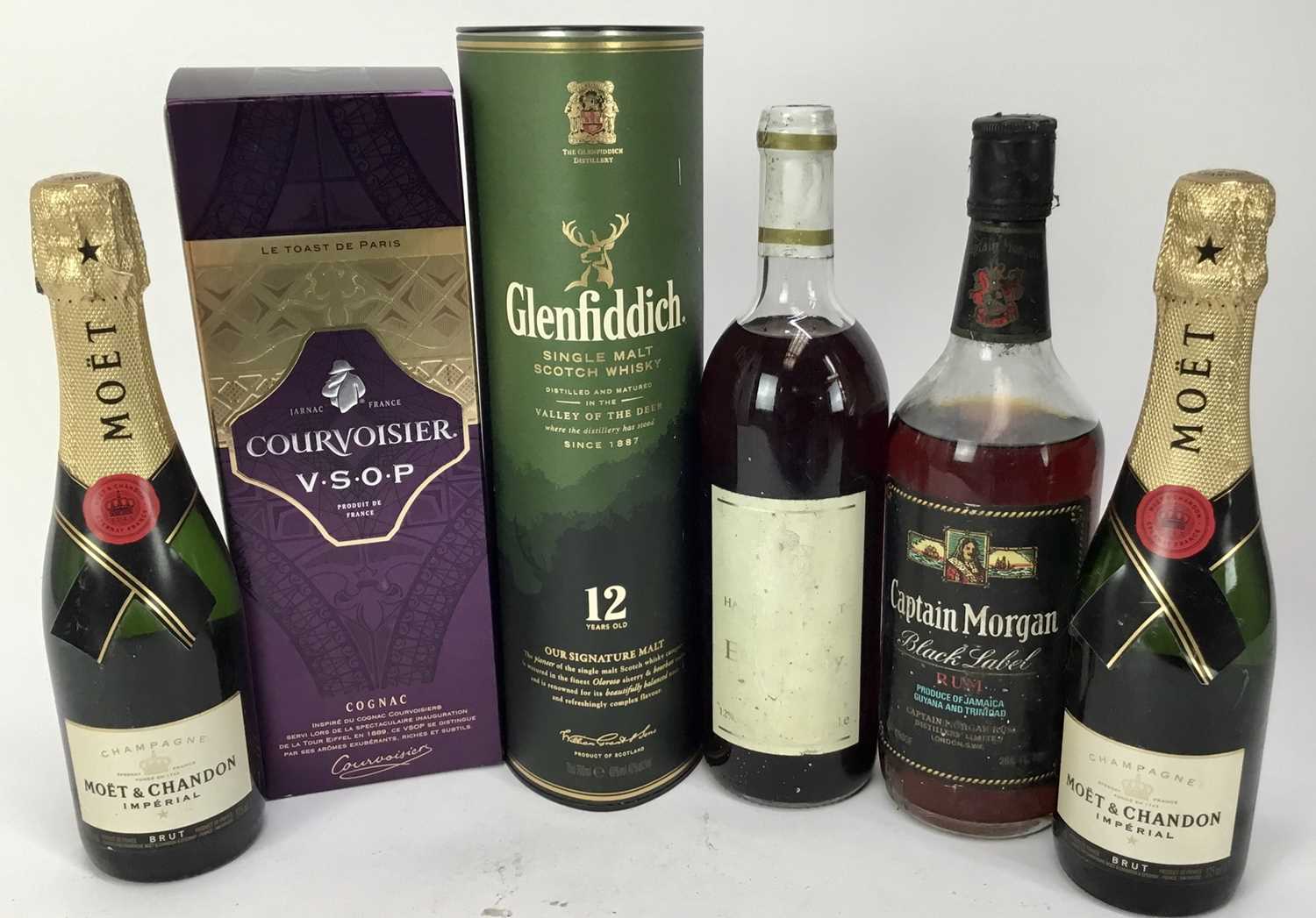 Lot 102 - Six bottles - Moët & Chandon two half bottles, Courvoisier V.S.O.P, Glenfiddich 12 year old whisky, Hampton Court Elderberry wine and Captain Morgan rum