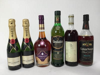 Lot 102 - Six bottles - Moët & Chandon two half bottles, Courvoisier V.S.O.P, Glenfiddich 12 year old whisky, Hampton Court Elderberry wine and Captain Morgan rum