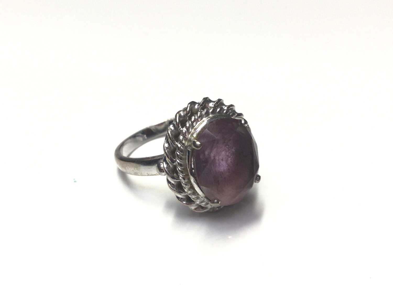 Lot 29 - White gold (stamped 585) purple stone cocktail ring