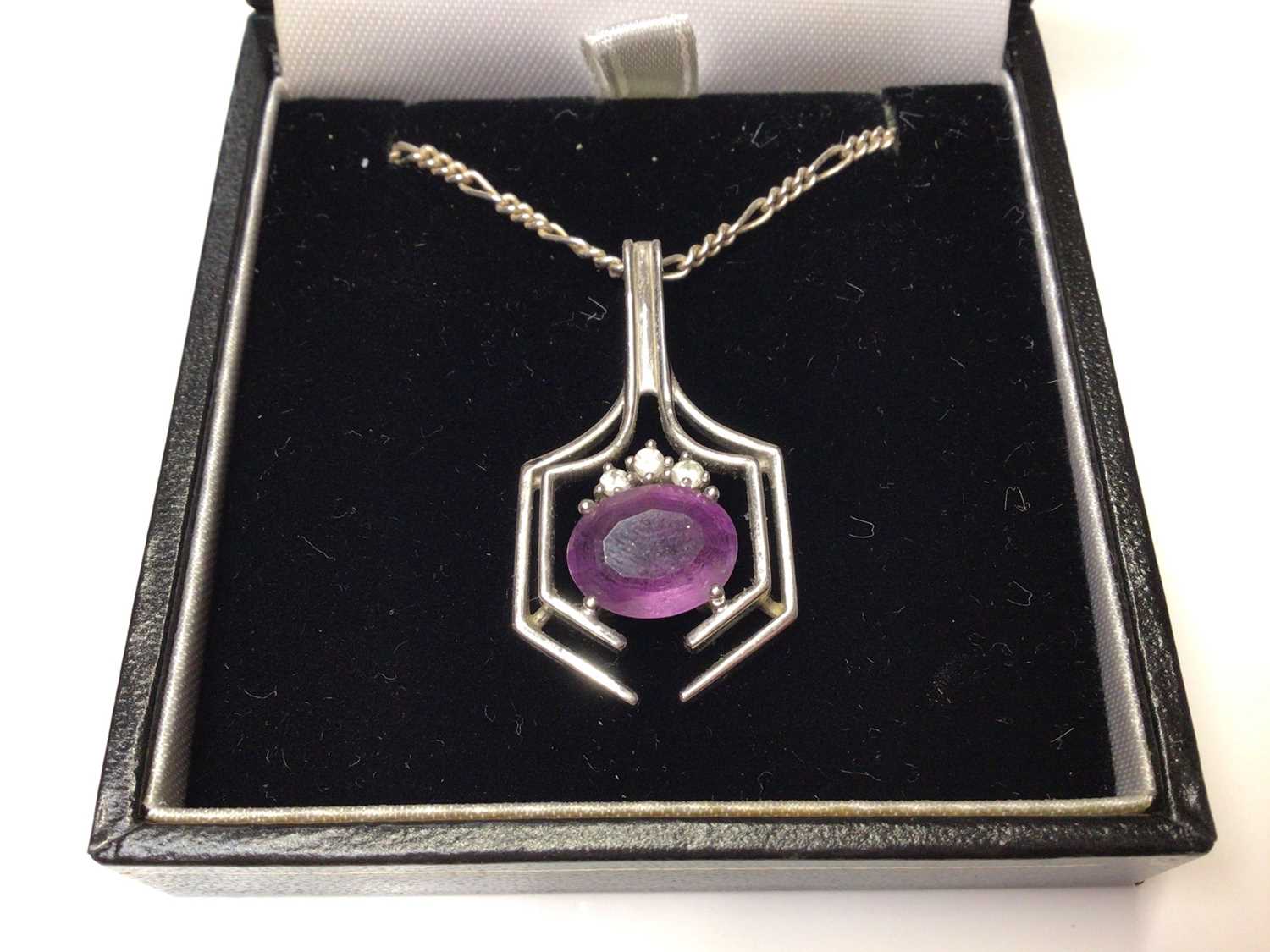 Lot 43 - 18ct white gold diamond and amethyst pendant on a silver chain.