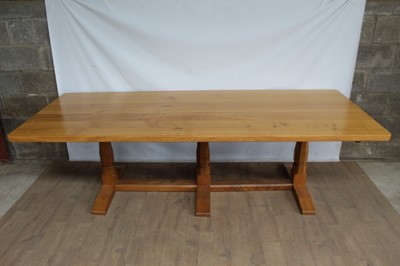 Lot 1309 - Rare Derek Slater 'lizard-man' oak refectory table, with associated plank top on facetted trestle supports united by foot stretchers, with signature lizard carved to base