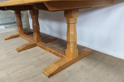 Lot 1309 - Rare Derek Slater 'lizard-man' oak refectory table, with associated plank top on facetted trestle supports united by foot stretchers, with signature lizard carved to base