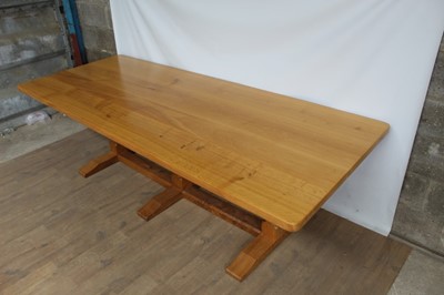 Lot 1309 - Rare Derek Slater 'lizard-man' oak refectory table, with associated plank top on facetted trestle supports united by foot stretchers, with signature lizard carved to base