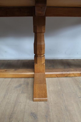 Lot 1309 - Rare Derek Slater 'lizard-man' oak refectory table, with associated plank top on facetted trestle supports united by foot stretchers, with signature lizard carved to base