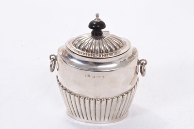 Lot 356 - Edwardian silver tea caddy of oval form, with twin ring handles, fluted decoration and hinged domed cover, with turned wood finial (Birmingham 1903), maker W D. All at approximately 4ozs. 11.5cm ov...