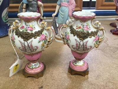Lot 126 - A small pair of Sèvres ormolu-mounted porcelain urns, 19th century, decorated with floral sprays and swags, with rococo scrollwork, marks to bases, 13cm high