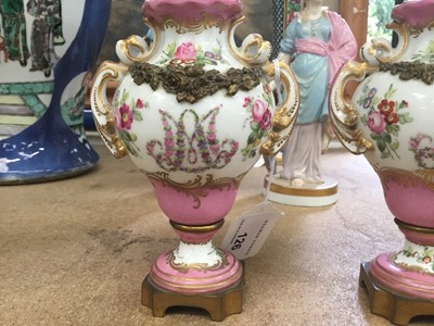 Lot 126 - A small pair of Sèvres ormolu-mounted porcelain urns, 19th century, decorated with floral sprays and swags, with rococo scrollwork, marks to bases, 13cm high
