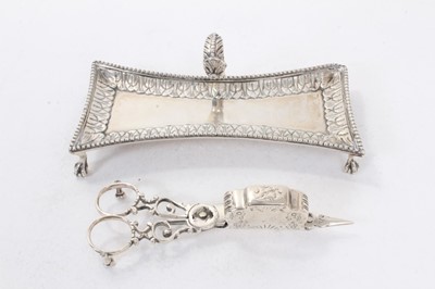 Lot 372 - George III silver scissor action candle snuffer / wick trimmer of conventional form, (London 1772), maker John Booth, together with an associated silver tray, raised on four claw and ball feet (Lon...