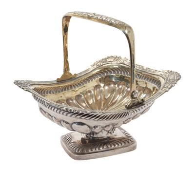 Lot 385 - 19th century Russian silver gilt sweet meat basket of rectangular form with fluted decoration, foliate borders and central swing handle, raised on pedestal foot, marks to interior- 84 and dated 183...
