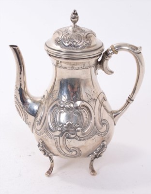 Lot 388 - 19th century continental silver coffee pot of baluster form with embossed floral and scroll decoration, raised on four scroll feet, marked to base (830), all at 12ozs, 20cm in overall height