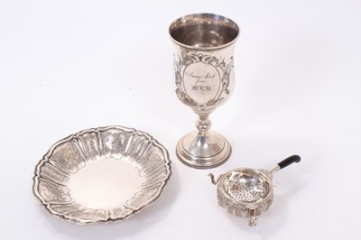 Lot 391 - Continental silver (800) dish of circular form, together with a white metal goblet and Middle Eastern silver tea strainer and stand, all 13.5oz (3)