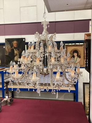 Lot 1375 - Large glass chandelier, with twelve scrolling candle arms issuing thirty dished lights with prismatic glass drops, approximately 95cm wide x 75cm high