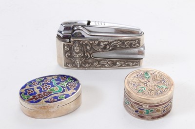 Lot 392 - Ronson Varaflame lighter with overlaid silver cover, marked Alex and Co, Sterling, together with an oval white metal and enamel pill box and a similar circular one (apparently unmarked) (3).