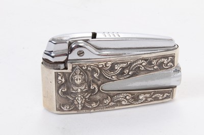 Lot 392 - Ronson Varaflame lighter with overlaid silver cover, marked Alex and Co, Sterling, together with an oval white metal and enamel pill box and a similar circular one (apparently unmarked) (3).