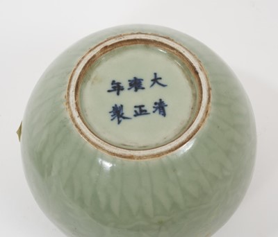 Lot 162 - Chinese celadon glazed vase, 19th century, with incised foliate patterns and Ruyi border, six-character Yongzheng mark to base, 9.5cm high, together with a Song period celadon glazed jarlet (2)