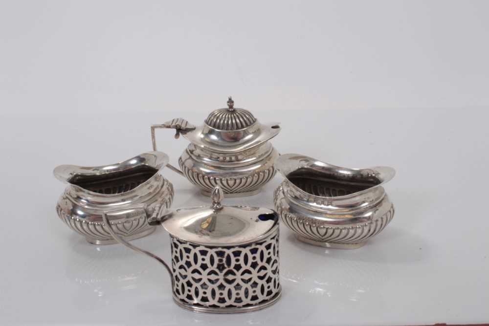 Lot 151 - Victorian silver mustard pot (Birmingham 1898), together with a pair of matching silver salts and another silver mustard pot, all at 4ozs (4)