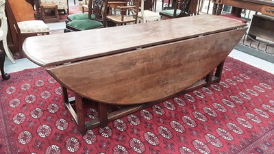 Lot 1448 - Good quality George III style wakes table with two drop flaps and gateleg action on square chamfered legs, opening to 150cm wide x 187cm long