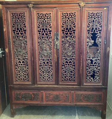 Lot 1449 - Antique Chinese cupboard with drawers and shelves enclosed by finely carved and pierced doors decorated with figures and foliage, 154cm wide x 180cm high x 54cm deep.