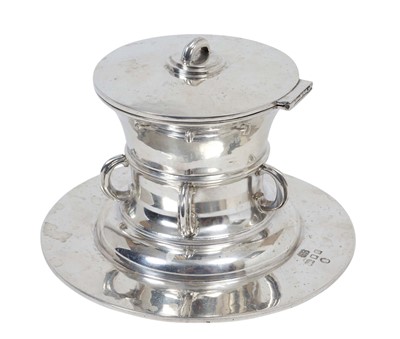 Lot 404 - George V silver inkwell in the Arts & Crafts style with hinged cover and interior containing removable glass inkwell and overall planished decoration, (Birmingham 1934). Maker Hicklenton & Phillips...