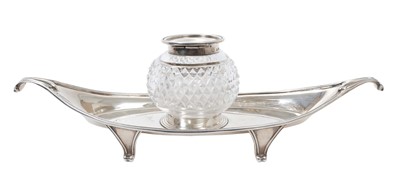 Lot 409 - George V silver inkstand of navette form with twin scroll handles and central silver mounted hobnail cut glass inkwell, raised on four feet, (London 1930), maker William Comyns & Sons Ltd, 8ozs of...