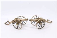 Lot 933 - Decorative pair brass model cannons on brass...