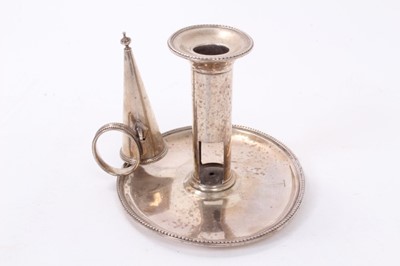 Lot 414 - George III silver chamberstick of oval form with beaded borders, removable snuffer and sconce, and engraved armorials, (London 1786), maker Thomas Chawner, all at 8ozs, 16cm in diameter.