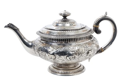 Lot 416 - George IV Scottish silver teapot of cauldron form with central band of embossed floral and foliate decoration, domed hinged cover and loop handle, raised on circular pedestal...