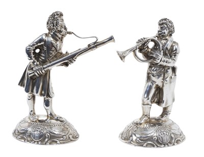 Lot 418 - Pair of German silver musician figures, on oval bases with floral and scroll decoration, stamped 835, all at 26ozs, 17cm in overall height.