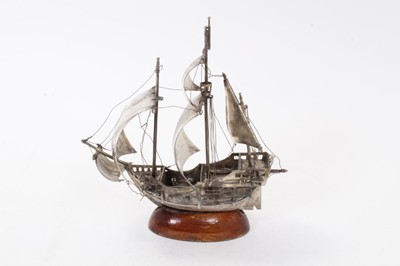 Lot 425 - Contemporary silver model of a galleon at sail, mounted on oval mahogany base, marked to bow, 22.5cm in height.