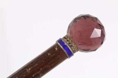 Lot 1017 - Edwardian walking stick with amethyst glass knop, ivory handled cane and two African hardwood canes with African head and snake decoration (4)