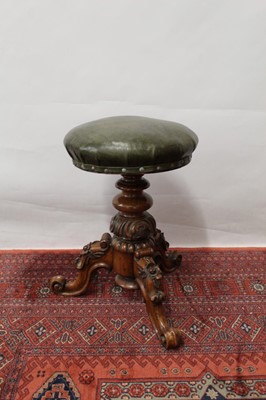 Lot 1451 - Victorian walnut revolving piano stool the circular green leather rising seat on acanthus carved knopped column and three leaf capped cabriole legs