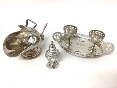 Lot 174 - Sterling silver caster, relief-decorated in the rococo style, together with a plated egg cruet and a plated sugar cattle and scoop