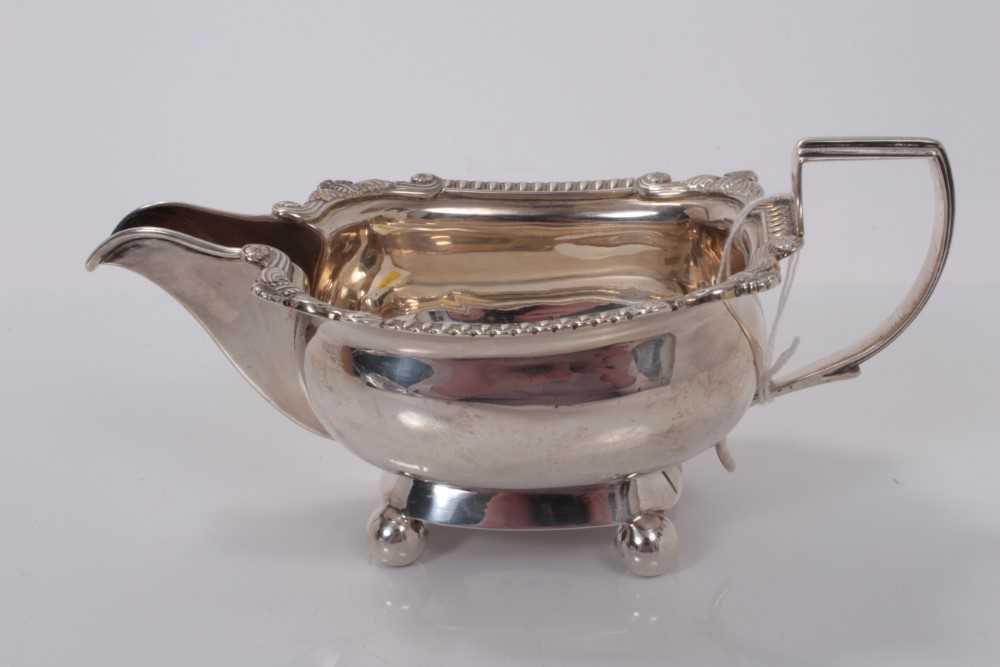Lot 42 - George III silver milk jug, raised on four ball feet, (London 1810), makers mark rubbed, 18.5cm in overall height, all at 6ozs
