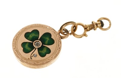 Lot 431 - Antique gold enamel and diamond 'lucky' locket with a green guilloché enamel lucky four-leaf clover to the front, centred with an old cut diamond and rose cut diamond bud, within engraved border, A...